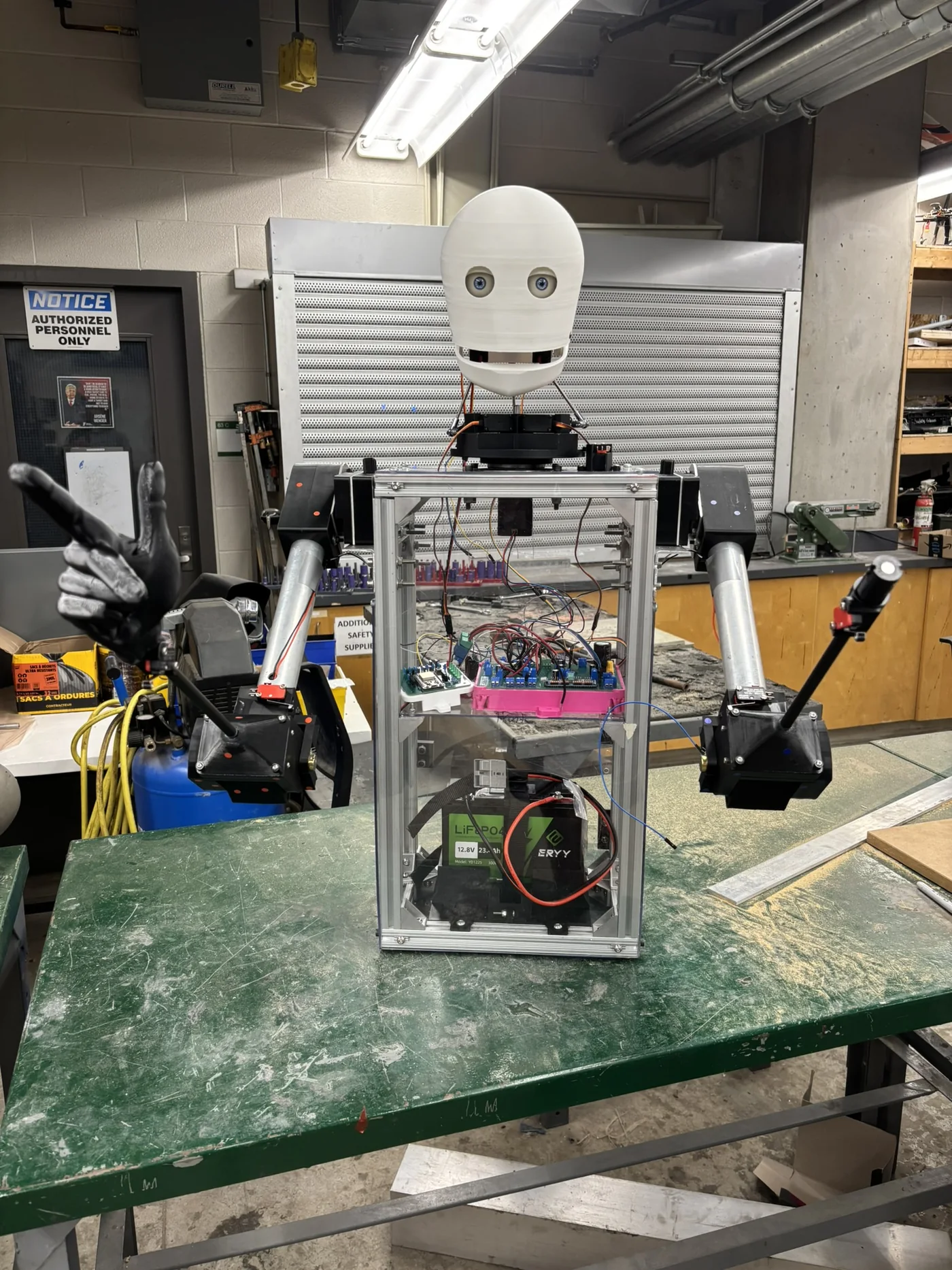 The waist-up Baker Bot on a workbench, with its head, arms and control electronics assembled.