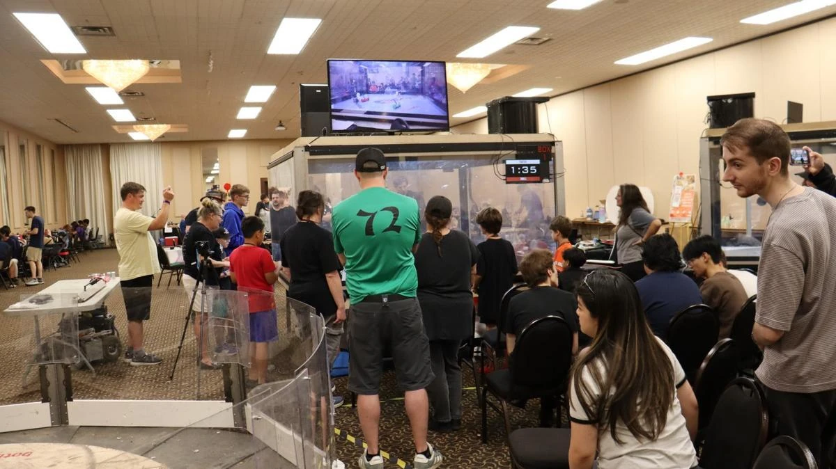 Spectators gathered around a robot combat arena at the BotBrawl Summer Classic.