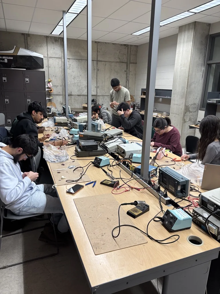 WE FIRST members learning electronics together at a workshop.